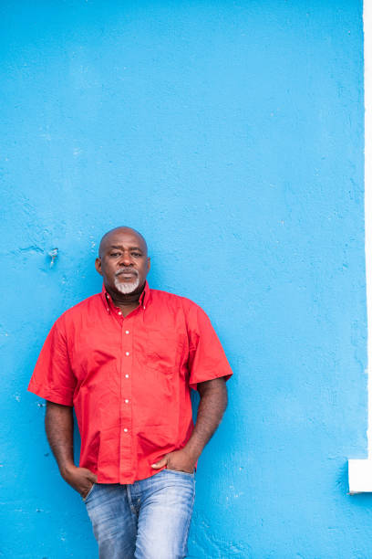 istock Mature afro man portrait on blue background 1148355021