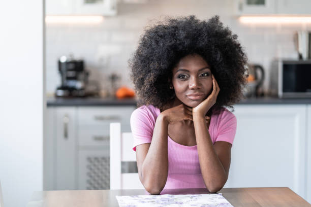 istock Thoughtfully african woman sitting home alone 1148355049