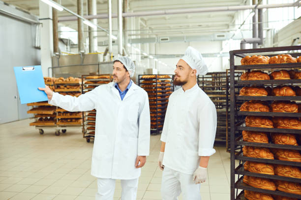 istock The technologist and baker speak in a bread factory. 1148355614