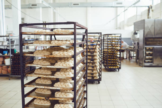 istock Fresh bread on trays before baking in the oven at the bakery 1148355630