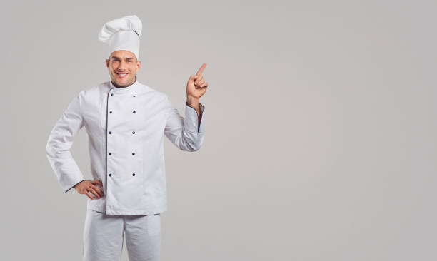 istock The guy the cook in white clothes smiles 1148358380