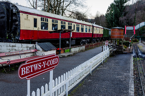 Betws-y-Coed, UK - Feb 2, 2019: The Conway Valley Railway Shop & Museum in Betws-y-Coed, North Wales. The platform for the narrow gauge railway with the catering carriage alongside.