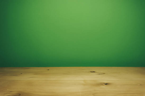 istock Beautiful white wooden table and green wall background. 1148361441