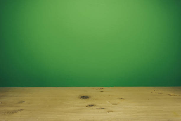 istock Beautiful white wooden table and green wall background. 1148361499