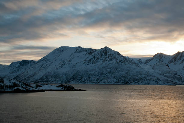 istock Winter arctic sunset over water with mountains in background 1148363619