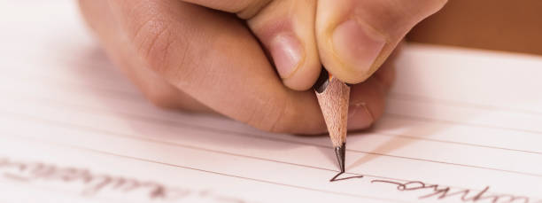 istock School Boy Writing Close Up. Pencil in Children Hand. 1148363739