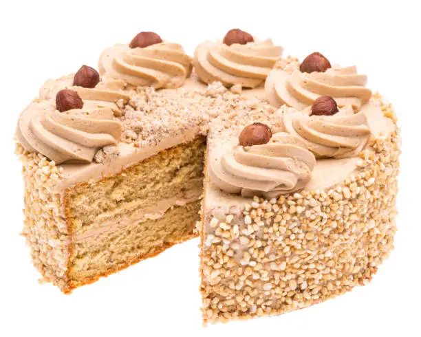 edible nut cake with one piece of cake missing isolated on white