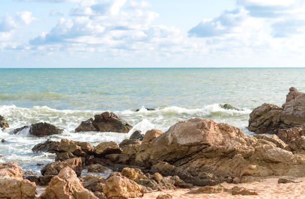 istock Waves crashing over the rock with cloud 1148373049