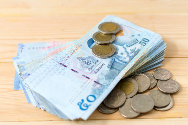 istock Stack Of Thai bank Note 50 Bath and Coins 1148373081