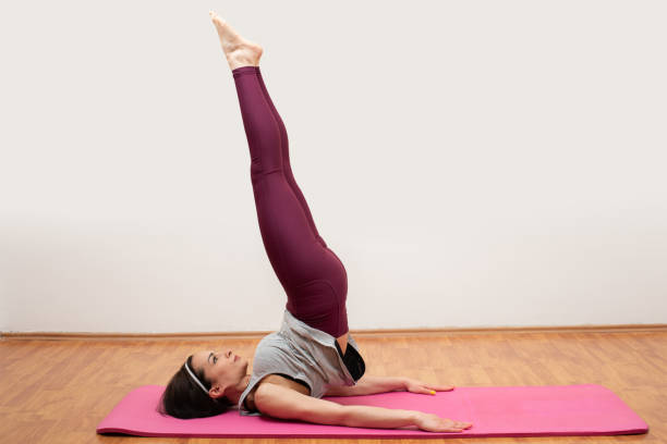 istock Young pilates teacher doing exercise on the mat 1148375316