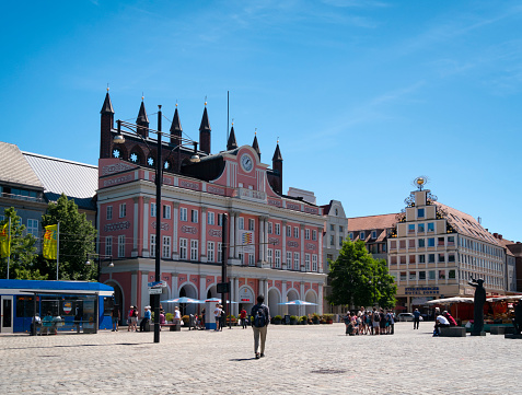 Locals and tourists in the Neuer Markt (New Market) near the ancient Rathaus (Town Hall) in this historic part of Rostock, a former Hanseatic League port city in Mecklenburg-Vorpommern, northern Germany.