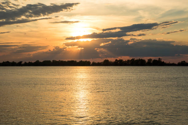 istock scenic orange sunset with beautiful clouds and blue sky on the river danube 1148377918