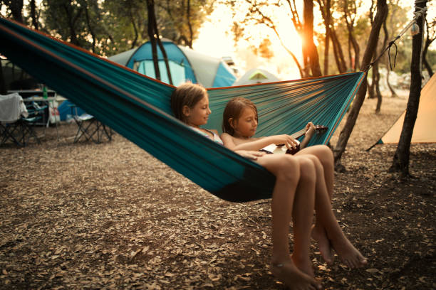 istock Children relaxing in hammock and playing ukulele 1148378995
