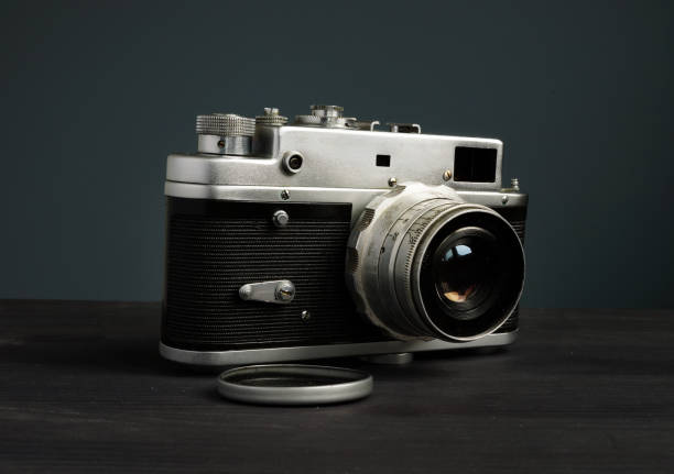 istock Old retro photo camera in the dark. Vintage devices. 1148379510