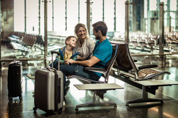 istock Happy parents and their son talking while waiting their transportation on a station. 1148382046
