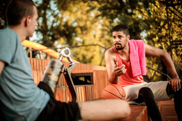 istock Friends chilling and talking while resting after a basketball game 1148382350