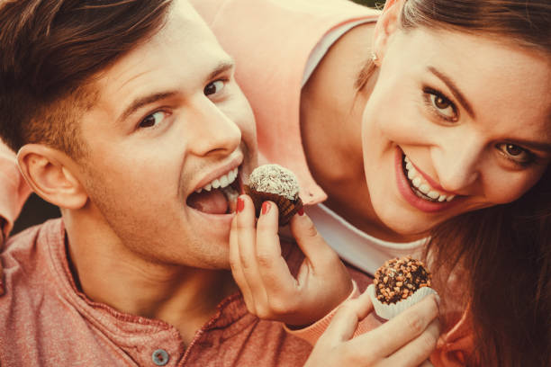 istock Smiling couple feeding each other. 1148383483