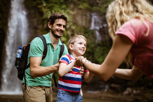 istock Happy parents assisting their small son in the rainforest. 1148383609
