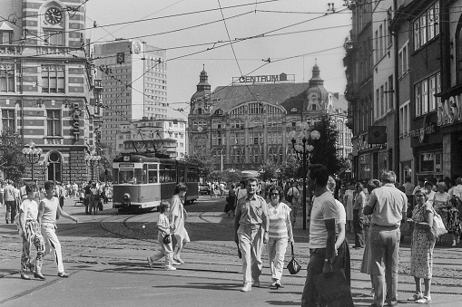 Erfurt, GDR, 1982 - Hustle and bustle at the Anger in the city center of Erfurt. In the middle of the numerous pedestrians meander the trams of the type Gotha.