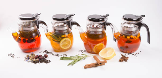 istock Glass transparent teapot on white backgrounf with tea ingredients 1148386059