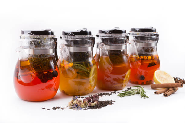 istock Glass transparent teapot on white backgrounf with tea ingredients 1148386073