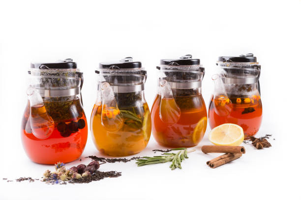Glass transparent teapot on white backgrounf with tea ingredients