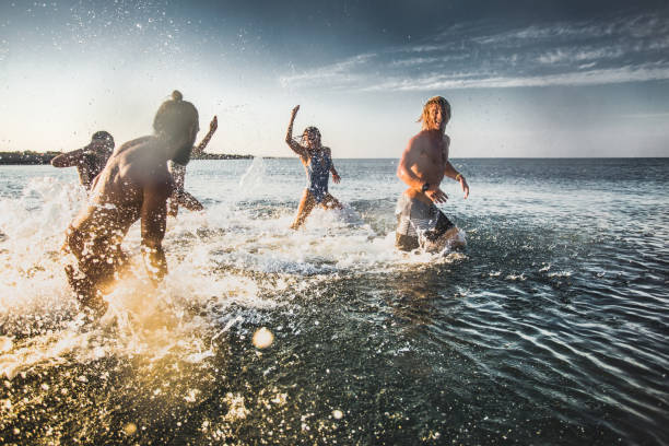 istock Group of happy people having fun while playing in the sea. 1148386169