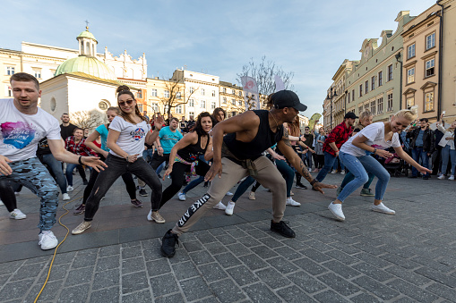 Cracow, Poland - Maerch 30, 2019:  International Flashmob Day of Rueda de Casino. Several hundred persons dance Hispanic rhythms on the Main Square in Cracow. Poland