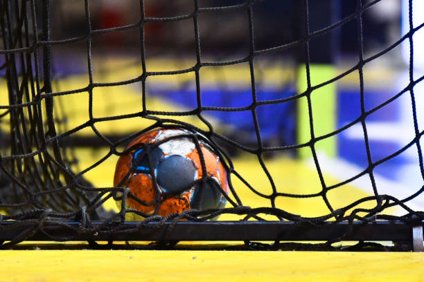 Handball ball and the net from the goal Handball ball and the net from the goal team handball stock pictures, royalty-free photos & images