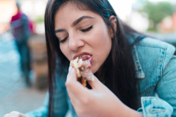 istock Girl Eating a Hamburger 1148394110