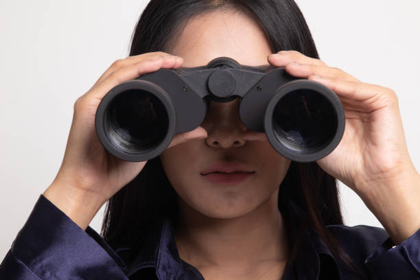istock Young Asian woman with binoculars. 1148394835