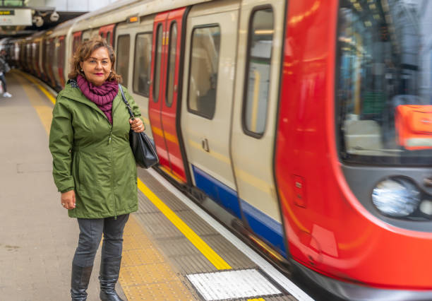 istock Mature Hispanic woman smiling on subway platform 1148395435