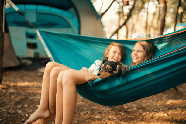 istock Children relaxing in hammock with dog 1148397651