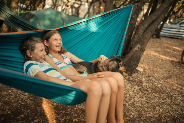 istock Children relaxing in hammock with dog 1148397669