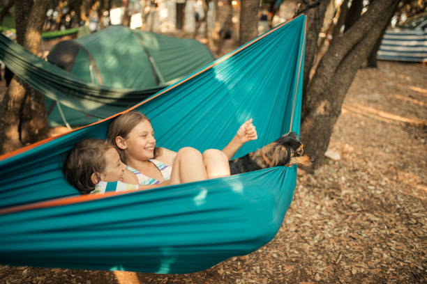 istock Children relaxing in hammock with dog 1148397689