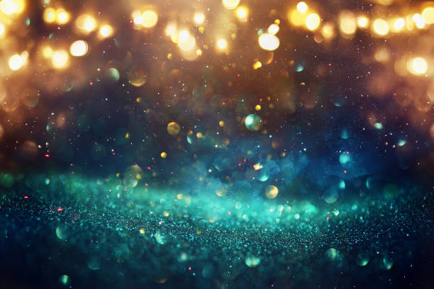 istock glitter vintage lights background. black, blue, gold and green. de-focused 1148399332