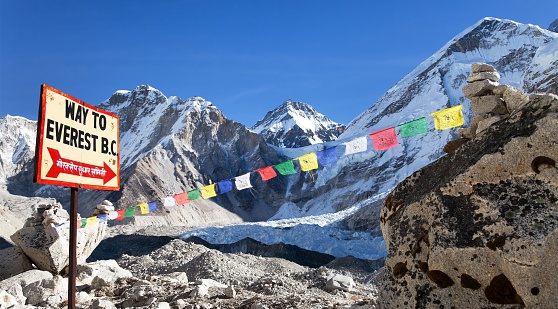 View from Mount Everest base camp, tents and prayer flags and signpost way to mount everest b.c. sagarmatha national park, trek to Everest base camp - Nepal Himalayas mountains