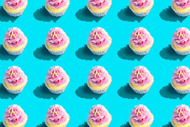 istock Colorful cupcake pattern on pastel blue background. Creative minimal party concept. 1148403556