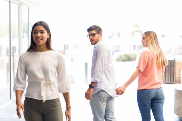 istock Insecure Woman Looking At Distracted Man 1148404342