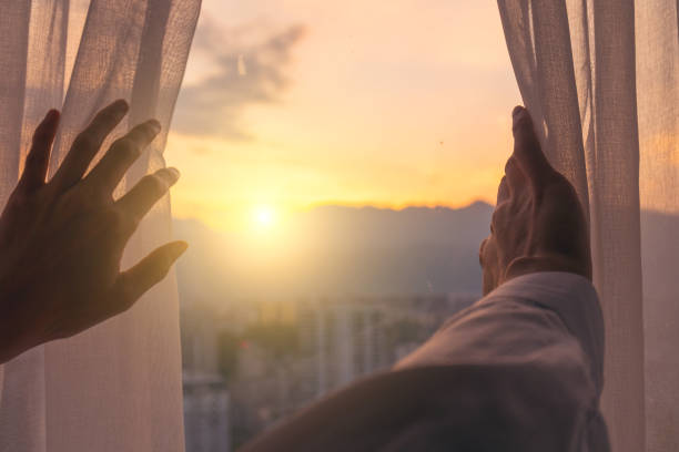 Man hand open curtain