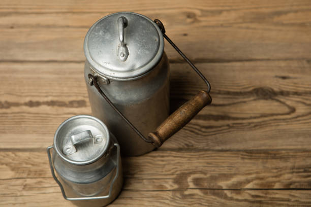 milk can on a wooden vintage background