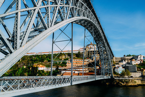 Porto, Portugal - April 29, 2019: Pedestrians on the Dom Luis I Bridge, a metal arch bridge that spans the Douro River between the cities of Porto and Vila Nova de Gaia, Portugal