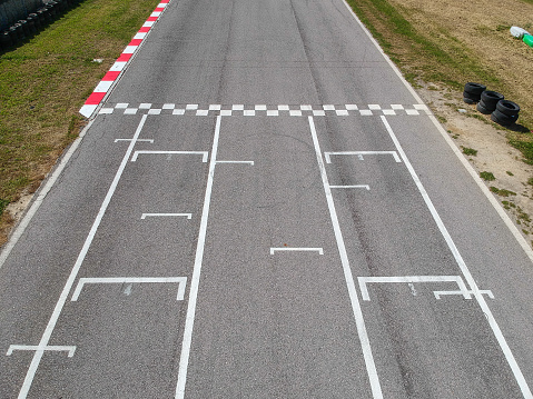 Race track with starting or end line, aerial view background