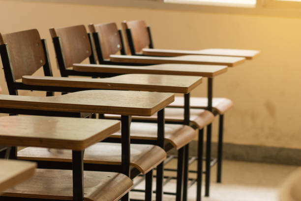istock Chair in empty classroom, lecture armchairs in school 1148411973