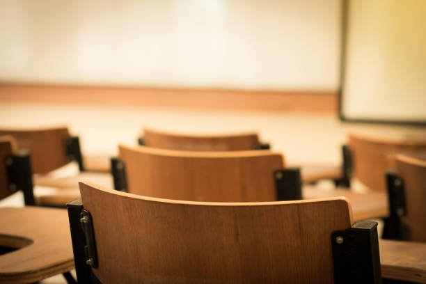 istock Chair in empty classroom, lecture armchairs in school, or college 1148412003