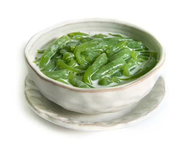 Photo of Thai dessert,Lod Chong Recipe Pandan Flavored Rice Flour Droplets in Sweetened Coconut Cream Syrup  isolated on white background