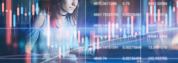 istock Young female model working at night modern office.Technical price graph and indicator, red and green candlestick chart and stock trading computer screen background. Double exposure.Wide. 1148413478