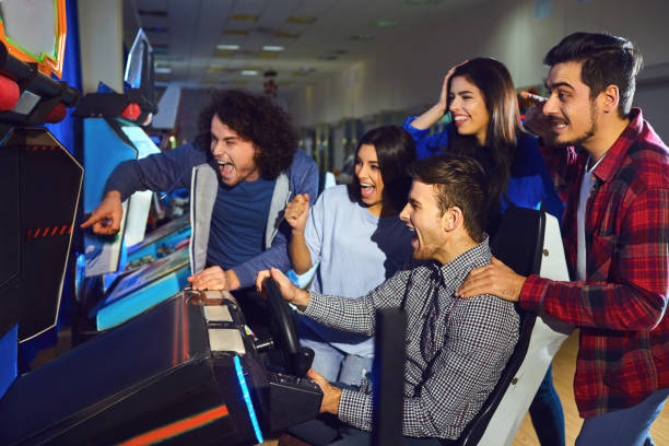istock A group of friends playing arcade machine. 1148416707