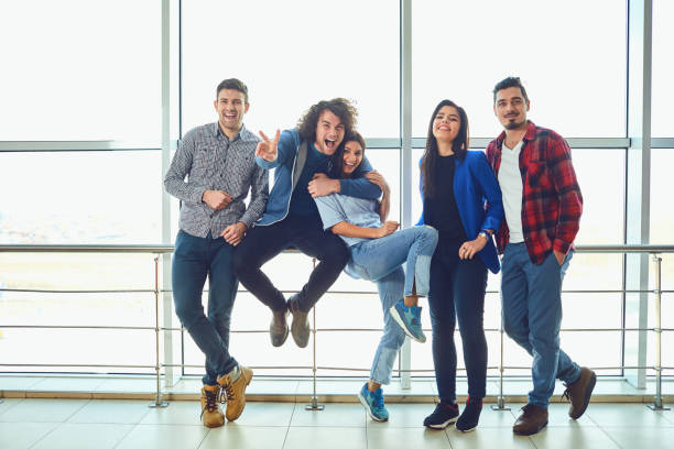 istock Young people stand against the window 1148416730