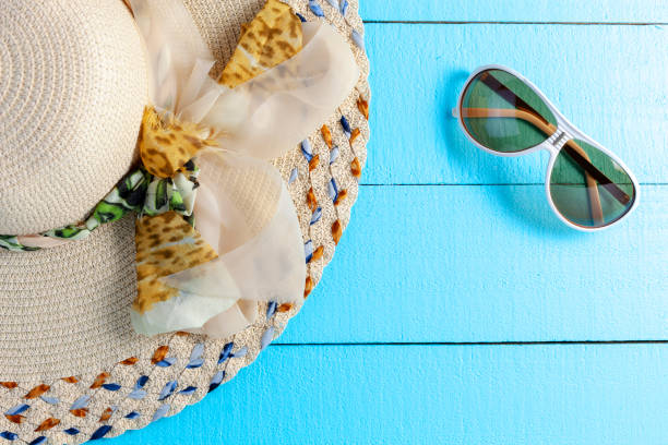 istock Beautiful lady hat beach on wood background copy space for your text 1148416915